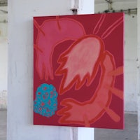 a red and blue painting hanging on a wall